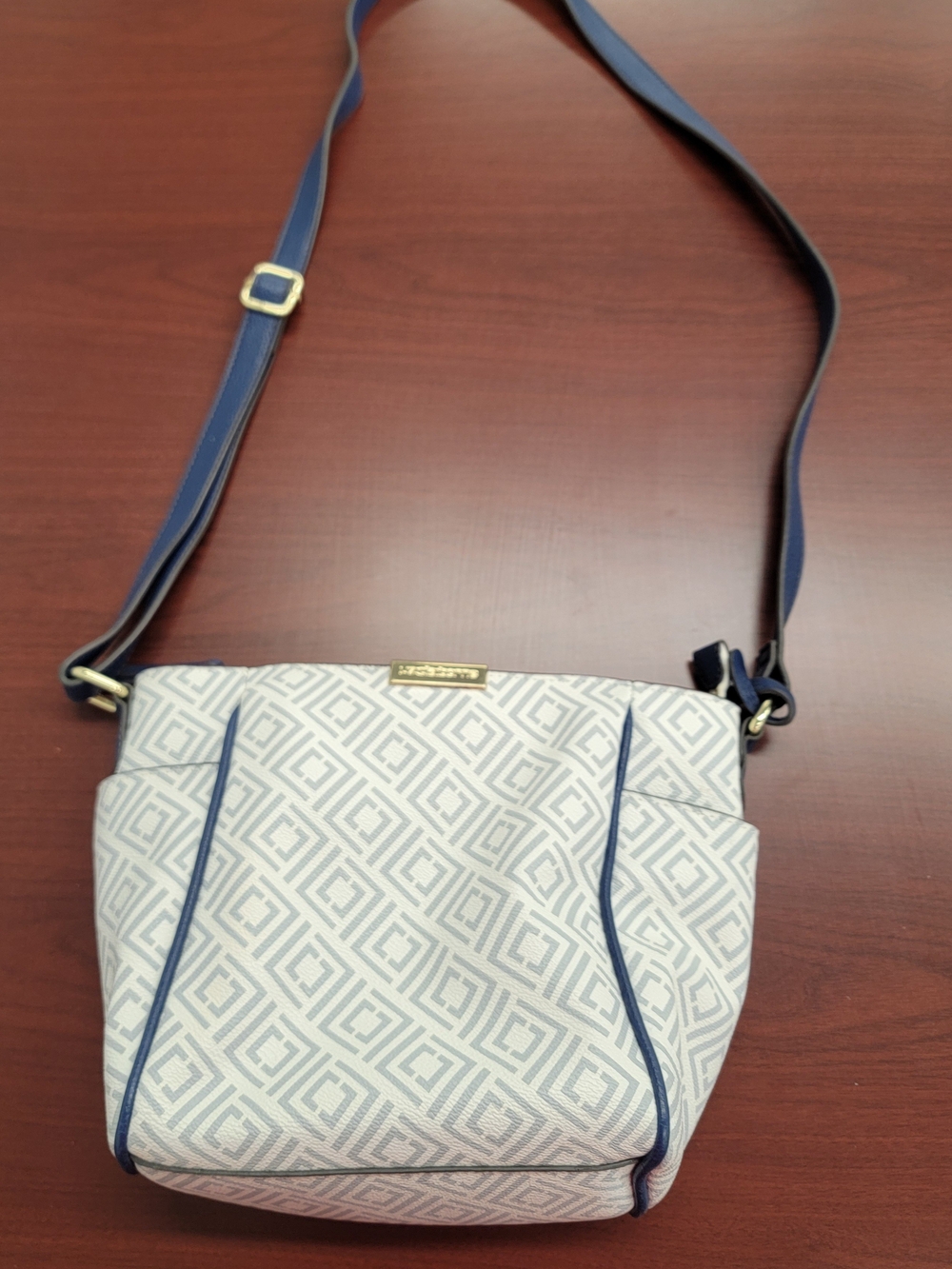 Stylish Liz Claiborne crossbody bag. White with light blue geometric pattern.